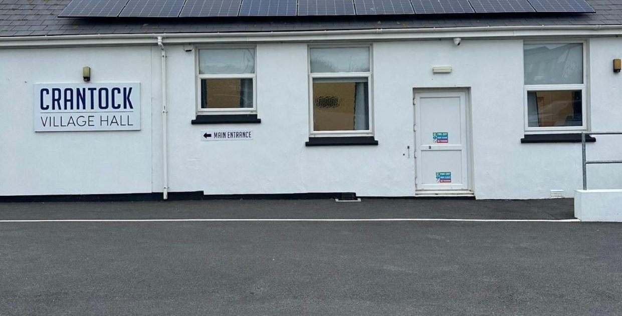 Crantock Village Hall with solar panels on the roof and its car park